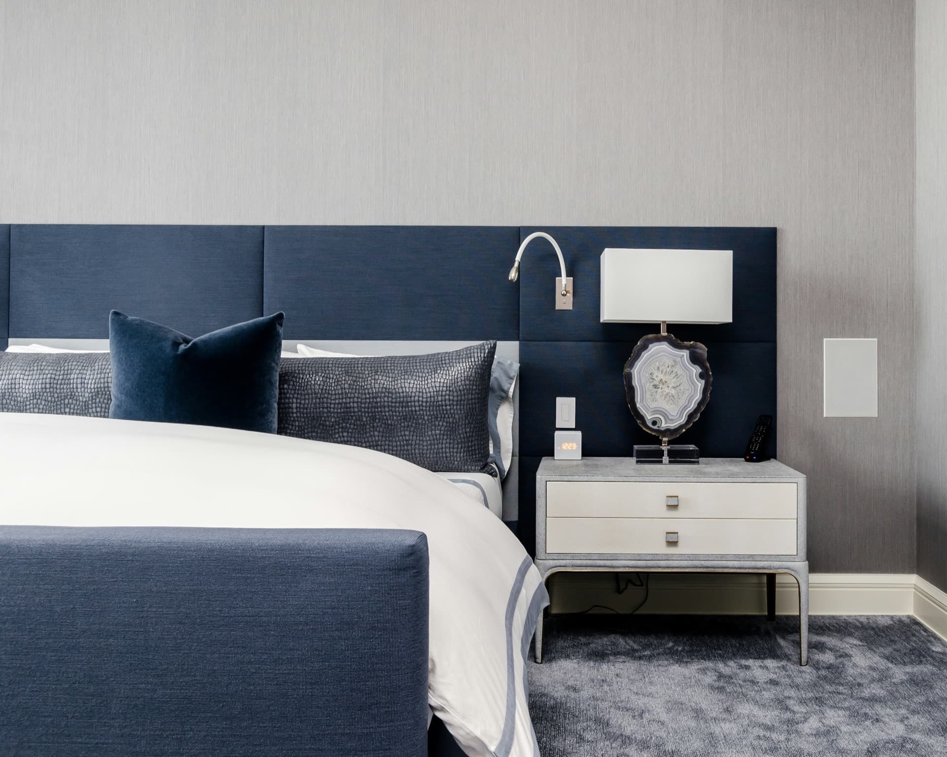 Elegant Neo Deco bedroom styling with a nightstand and lamp